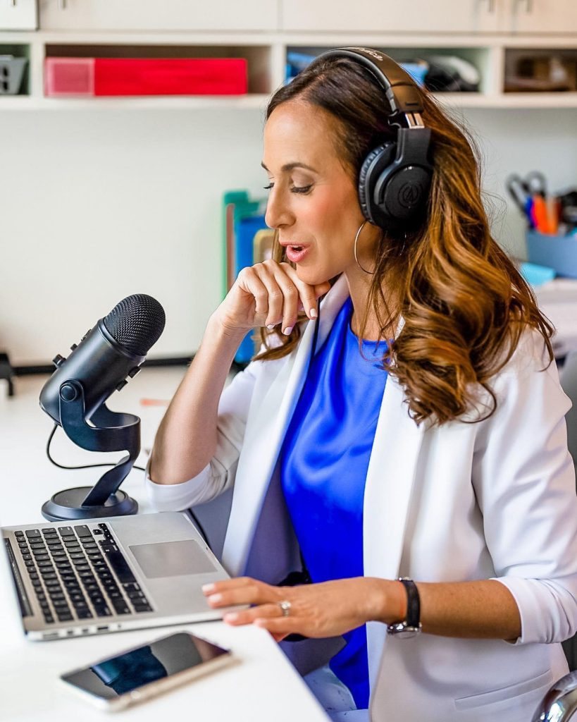 Erica Diamond recording the podcast at her microphone